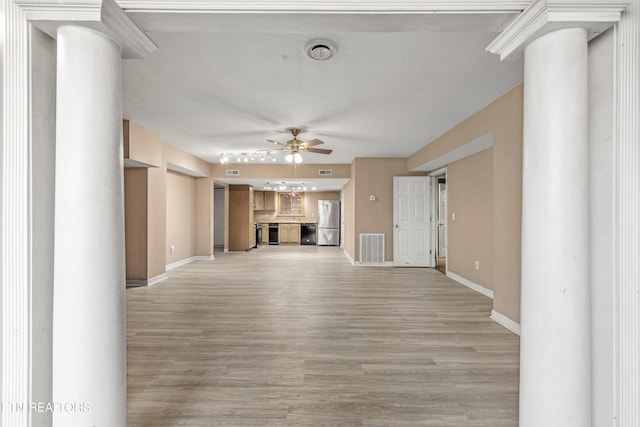 221 Woodland Rd Unit 315, Gatlinburg, TN 37738 - unfurnished living room with baseboards, visible vents, ornate columns, ceiling fan, and light wood finished floors