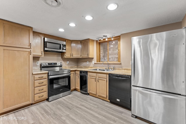 221 Woodland Rd Unit 315, Gatlinburg, TN 37738 - kitchen with light brown cabinets, light countertops, light wood-style floors, appliances with stainless steel finishes, and a sink