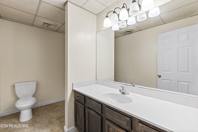221 Woodland Rd Unit 315, Gatlinburg, TN 37738 - bathroom with toilet, vanity, baseboards, and a drop ceiling