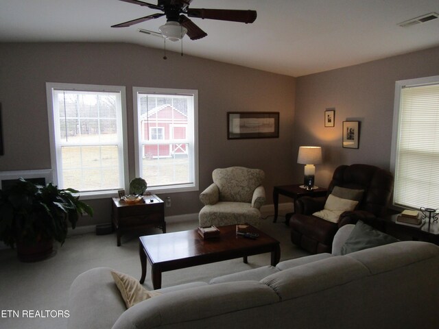 living room featuring visible vents, lofted ceiling, a ceiling fan, and carpet flooring