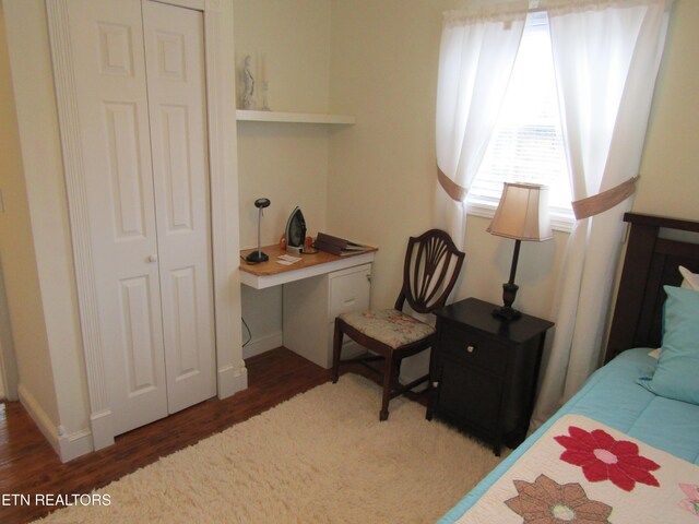 bedroom with a closet, baseboards, and wood finished floors
