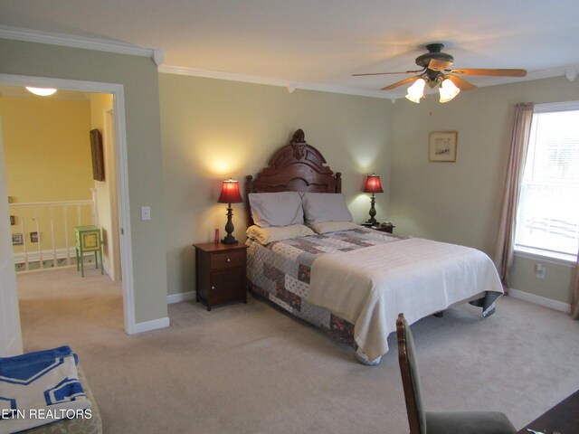 bedroom with baseboards, light carpet, and crown molding