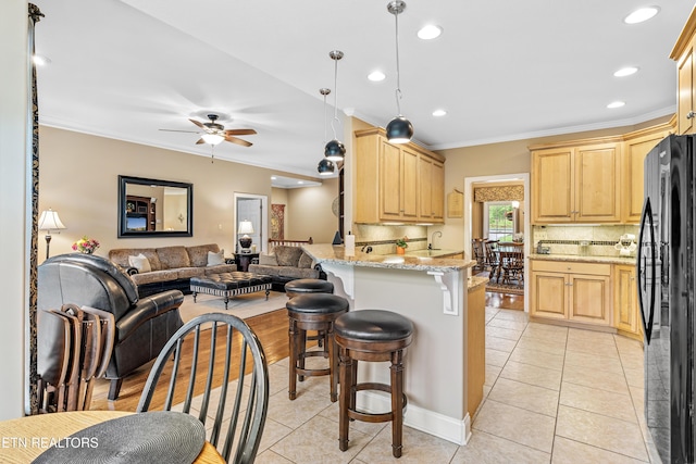 144 Nunyu Trl, Vonore, TN 37885 - kitchen featuring freestanding refrigerator, light brown cabinets, ornamental molding, tasteful backsplash, and a peninsula