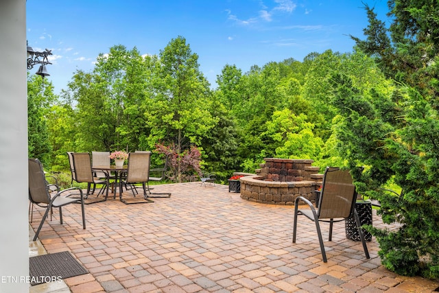 144 Nunyu Trl, Vonore, TN 37885 - view of patio featuring outdoor dining area and an outdoor fire pit