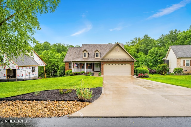 144 Nunyu Trl, Vonore, TN 37885 - view of front of house with brick siding, driveway, a front lawn, and a porch