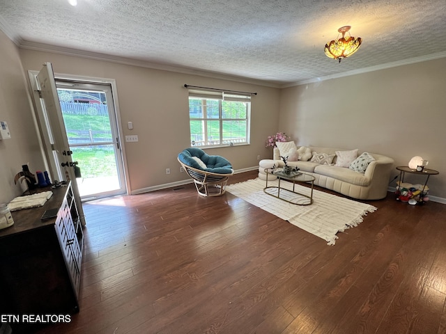 living area with hardwood / wood-style flooring, baseboards, crown molding, and a textured ceiling