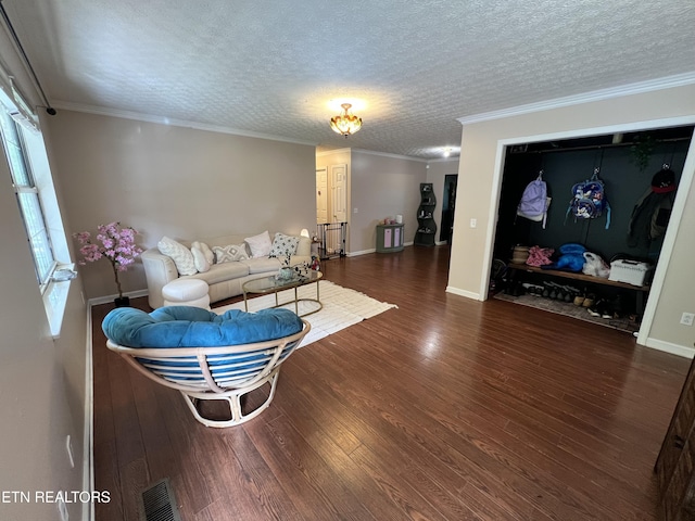 living area with wood finished floors, visible vents, ornamental molding, baseboards, and a textured ceiling