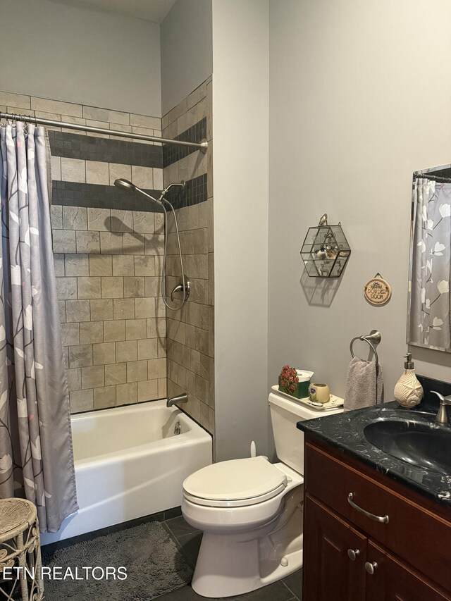 bathroom featuring tile patterned floors, vanity, shower / tub combo with curtain, and toilet