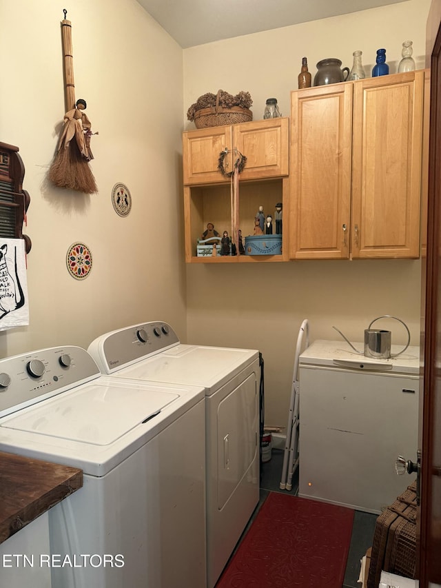 washroom featuring cabinet space and independent washer and dryer