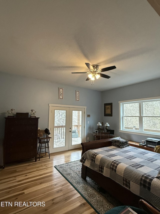 bedroom with french doors, access to exterior, a ceiling fan, and light wood-style floors
