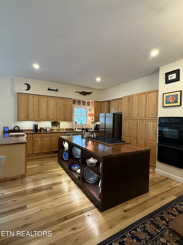 kitchen with recessed lighting, light wood-style floors, and appliances with stainless steel finishes