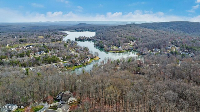 bird's eye view featuring a wooded view and a water and mountain view