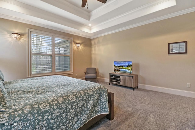carpeted bedroom featuring baseboards, ceiling fan, ornamental molding, and a raised ceiling
