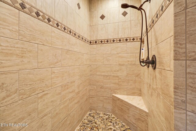 full bathroom with tiled shower