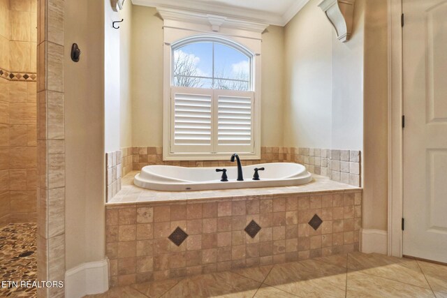 full bath featuring a tile shower, a garden tub, tile patterned floors, and crown molding