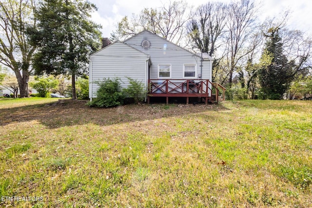 rear view of house with a chimney and a deck