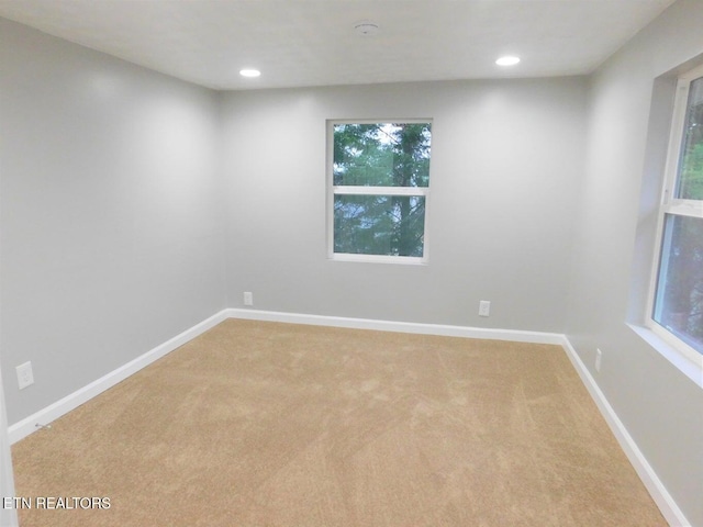 unfurnished room featuring baseboards, light colored carpet, and recessed lighting