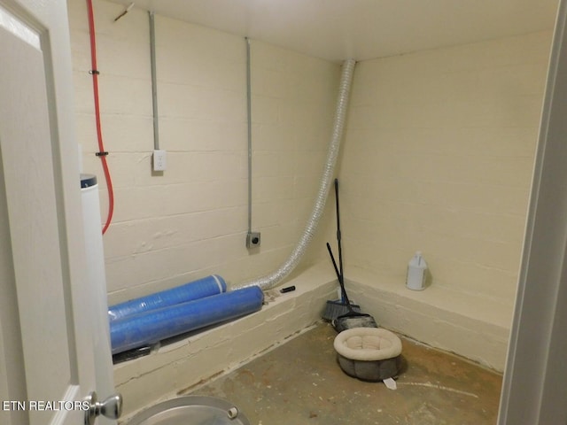 bathroom with concrete block wall