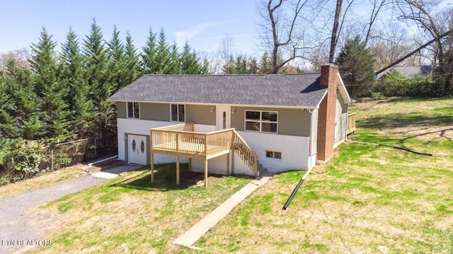 view of front of property featuring stairway, a wooden deck, a front lawn, a shingled roof, and a chimney