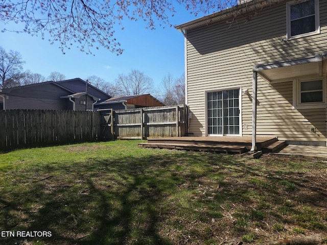 view of yard with a wooden deck and fence