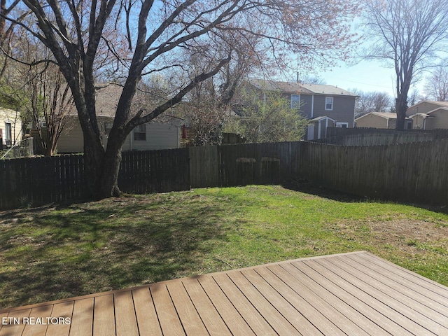 wooden terrace featuring a residential view and fence