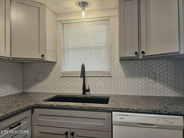 kitchen featuring a sink, a textured ceiling, backsplash, and dishwasher