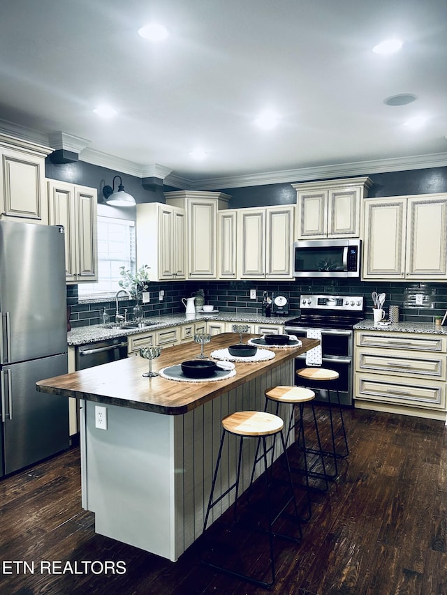 57 Riverview Dr, Oak Ridge, TN 37830 - kitchen featuring appliances with stainless steel finishes, tasteful backsplash, wooden counters, and a sink