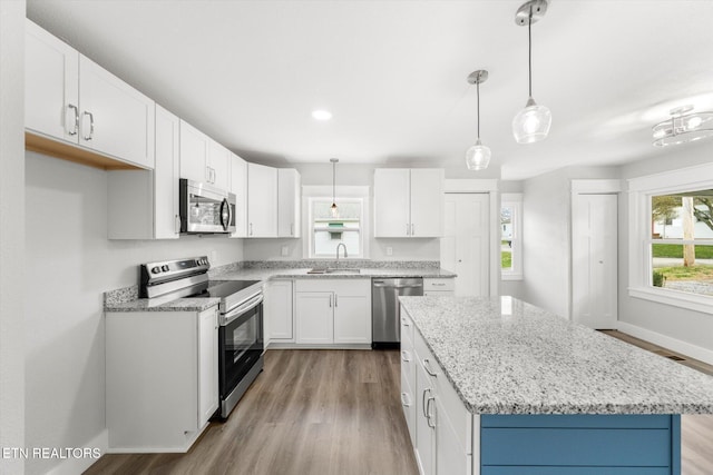 kitchen featuring stainless steel appliances, a sink, and light wood-style floors