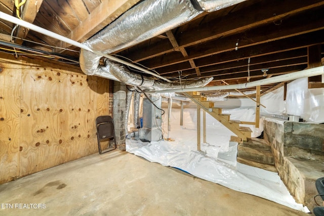 unfinished below grade area featuring heating unit