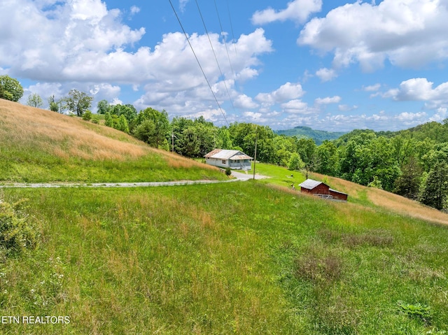 869 Poplar Grove Rd, Harrogate, TN 37752 - view of yard featuring a view of countryside, a wooded view, and an outdoor structure