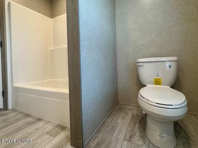 bathroom featuring toilet and wood finished floors