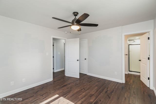 unfurnished bedroom featuring a ceiling fan, dark wood-type flooring, and baseboards