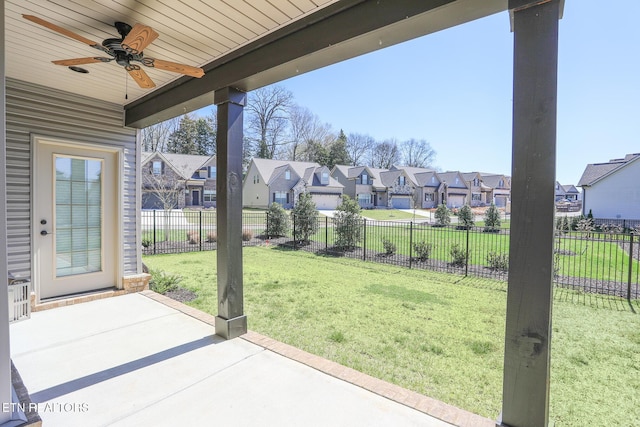 view of patio with a fenced backyard, a residential view, and ceiling fan