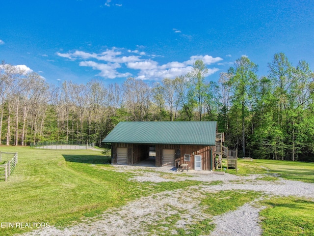 145 Horse Haven Rd, Allardt, TN 38504 - view of pole building with stairs, a yard, and a forest view