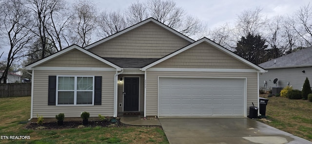 ranch-style house with driveway, an attached garage, fence, and a front yard