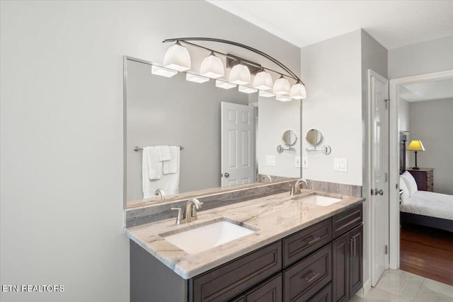 ensuite bathroom with ensuite bathroom, double vanity, and a sink