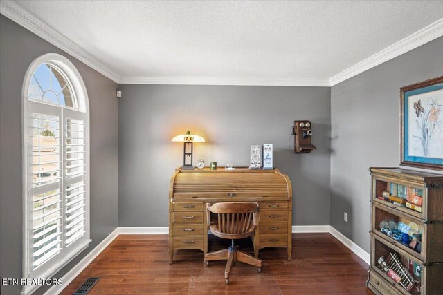 office space featuring baseboards, visible vents, and wood finished floors