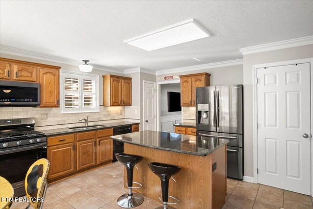 kitchen with a sink, a kitchen island, brown cabinetry, light tile patterned floors, and stainless steel appliances