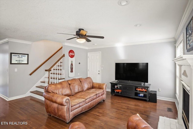 living room featuring baseboards, wood finished floors, stairway, and crown molding
