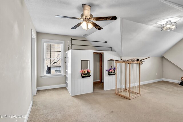 unfurnished living room with baseboards, lofted ceiling, carpet, and a ceiling fan