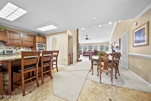102 Baskins Creek Byp Unit 604, Gatlinburg, TN 37738 - dining space featuring a textured ceiling, ornamental molding, vaulted ceiling, and a toaster