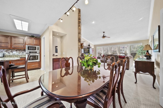102 Baskins Creek Byp Unit 604, Gatlinburg, TN 37738 - dining area featuring a ceiling fan, ornamental molding, vaulted ceiling, and a textured ceiling