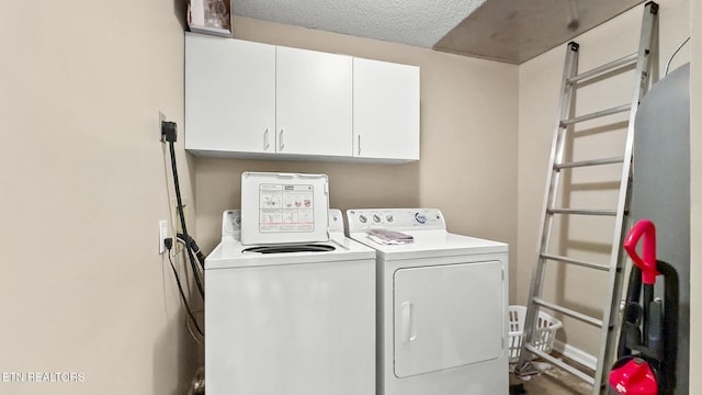 102 Baskins Creek Byp Unit 604, Gatlinburg, TN 37738 - laundry area featuring cabinet space, a textured ceiling, and washer and clothes dryer