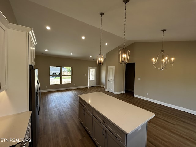 kitchen featuring open floor plan, dark wood-type flooring, refrigerator with ice dispenser, and light countertops