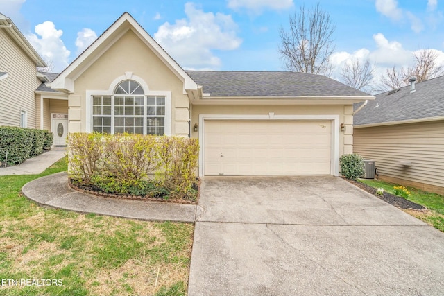 ranch-style house featuring a shingled roof, concrete driveway, stucco siding, and an attached garage