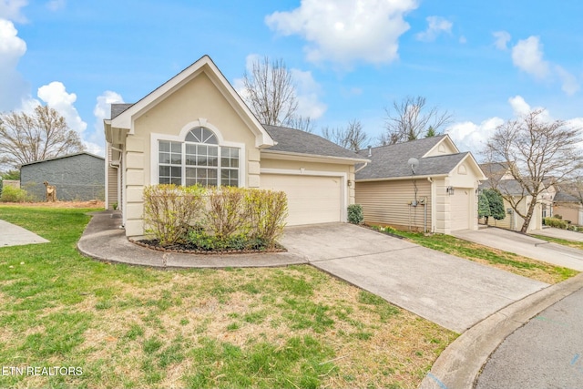 view of front of property featuring a front lawn, driveway, stucco siding, and a garage