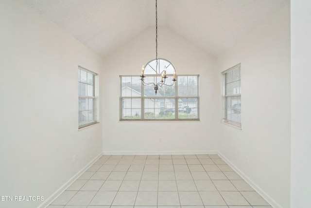 unfurnished room featuring a notable chandelier, baseboards, and vaulted ceiling