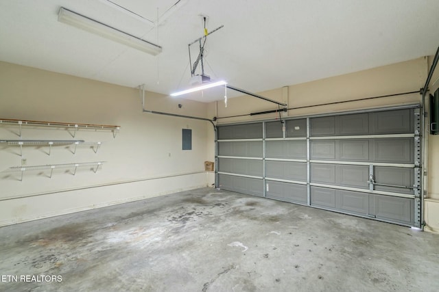 garage featuring electric panel and a garage door opener