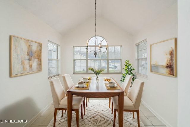 dining area with baseboards, lofted ceiling, an inviting chandelier, and light tile patterned floors