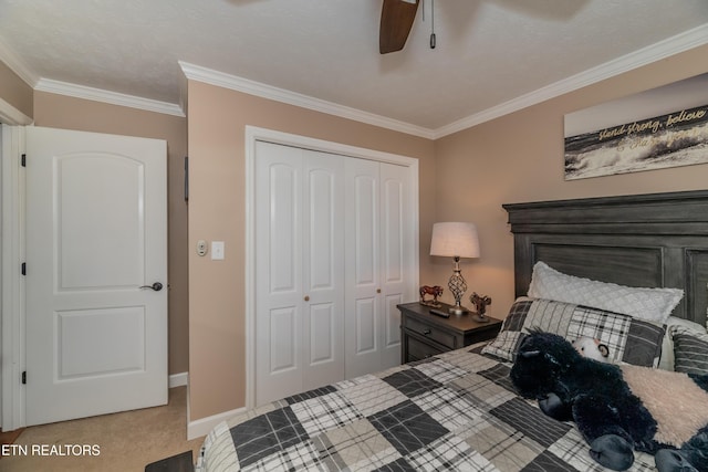 bedroom featuring a closet, baseboards, ornamental molding, ceiling fan, and light carpet